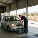 Inspector checking a car's headlights in an inspection hall on the Costa del Sol while the owner waits