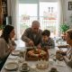 Spanish family with children and grandparents sharing a roscón de Reyes at home on Three Kings morning