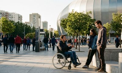 Three young friends chatting outdoors on a sunny Madrid street near the stadium before a football match
