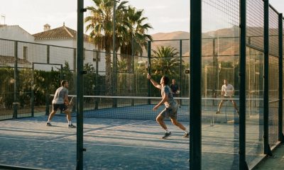 Four people playing a doubles padel match on an outdoor court in southern Spain