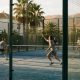 Four people playing a doubles padel match on an outdoor court in southern Spain