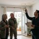 Couple showing a loss adjuster a water-stained ceiling in a whitewashed apartment in southern Spain