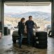 Mechanic and customer next to a car with winter tyres in a Spanish garage