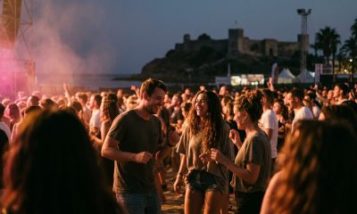 Friends dancing at an open-air summer concert by the sea on the Costa del Sol at dusk