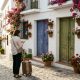 Traveller comparing a photo on her phone with the entrance of a house in Mijas